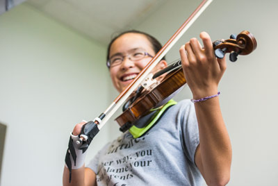 A 3D printed prosthetic hand brings out the music for Sarah Valentiner. Courtesy of NIU.